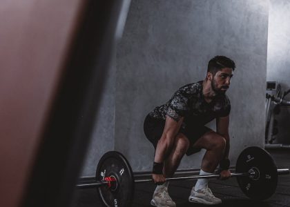 Man lifting weights in gym, displaying strength and focus. Ideal for fitness and training themes.